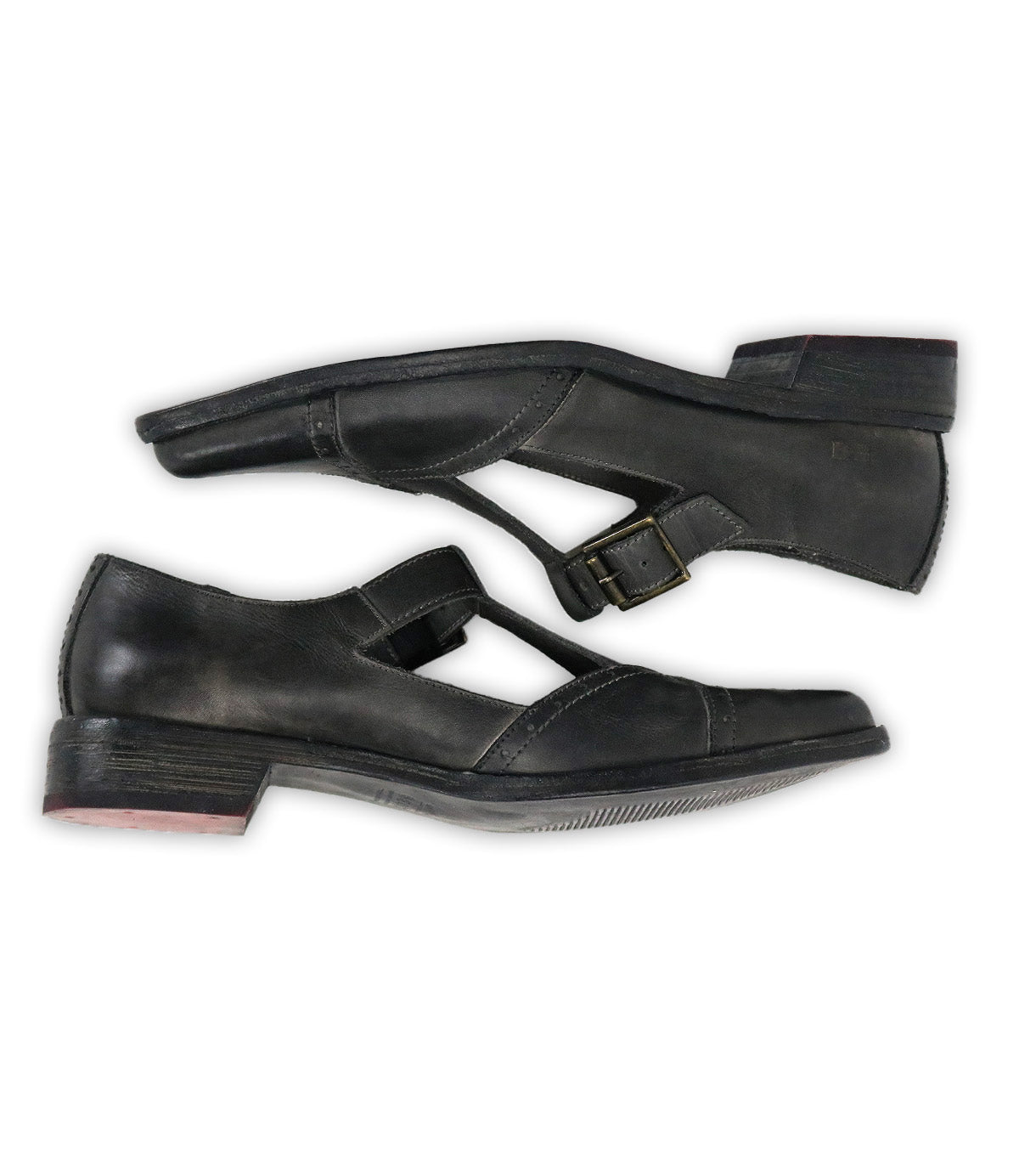 A side-profile image of the Bed|Stü Jenny shoes, featuring black leather Mary Jane T-straps with a low heel, buckle closure, cushioned insole, and light wear on the soles, set against a white background.