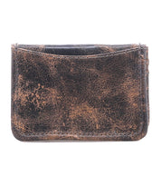The Jeor card wallet by Bed|Stü is crafted from distressed brown rustic leather with visible scuffs and creases, offers practical credit card slots, and is photographed against a white background.