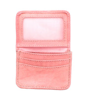 A small, open Bed|Stü Jeor wallet in pink, featuring credit card slots and a clear ID window, photographed against a white background.