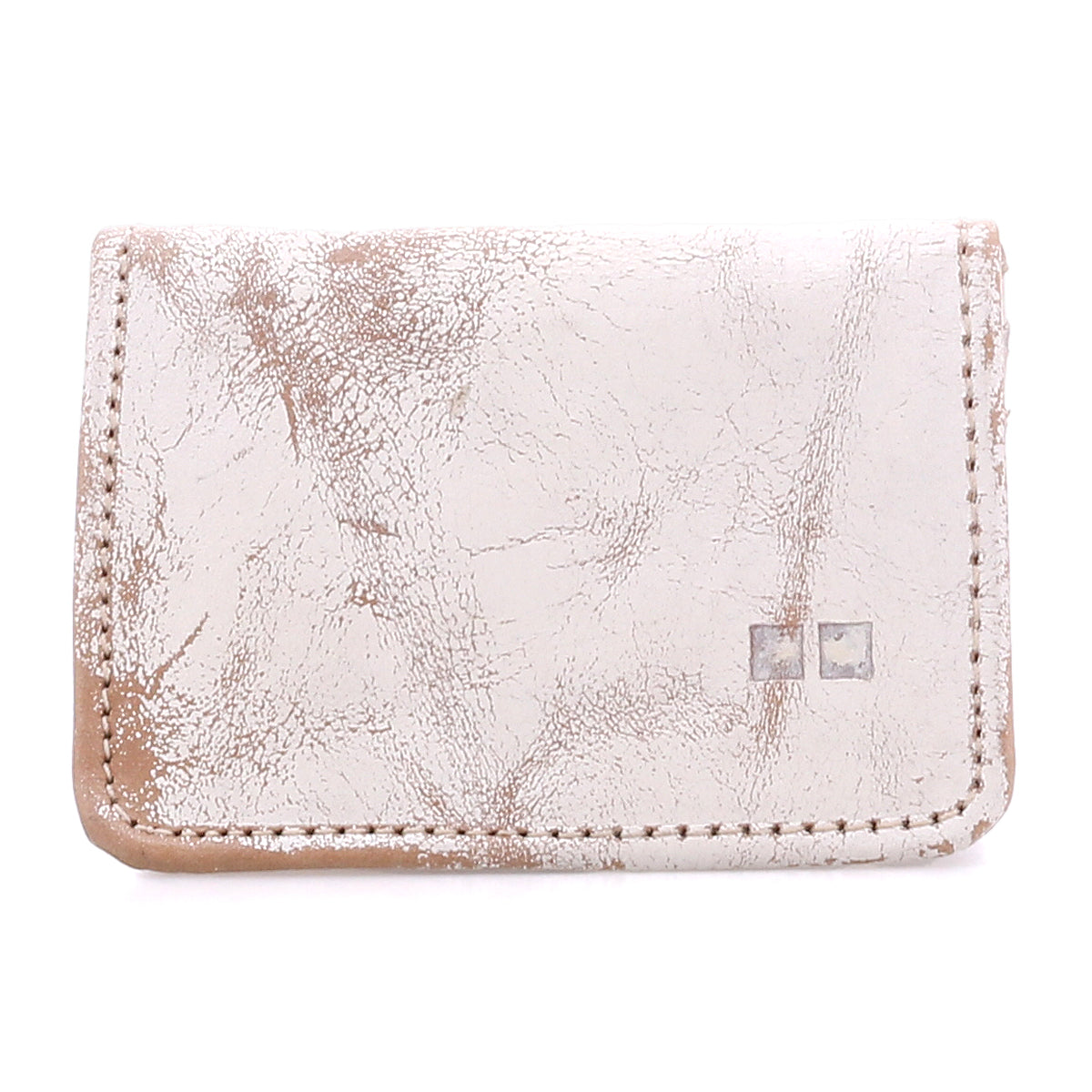 Introducing the Jeor by Bed|Stü—a compact, rustic leather card wallet in a light hue, distinguished by its visible creases and scuffs for authentic vintage appeal. Two small square metal accents adorn the front, while convenient credit card slots ensure easy organization without compromising style.