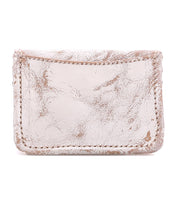 Introducing Jeor by Bed|Stü—a small, rectangular card wallet crafted from worn, light beige leather with a textured surface and visible stitching. This rustic accessory is photographed against a white background.