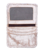 The Bed|Stü Jeor is a metallic, textured compact wallet featuring a clear ID window, two credit card slots, and an additional pocket, displayed open against a white background.