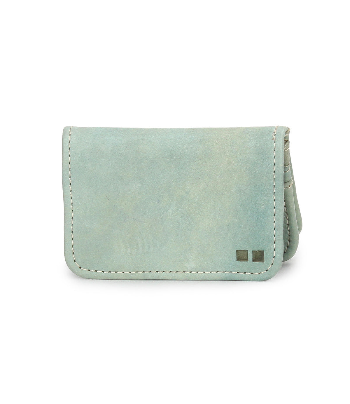 The Jeor card wallet by Bed|Stü features light blue rustic leather with visible stitching and two small metallic square accents on the bottom right corner. Designed with compact credit card slots, it is displayed against a white background.