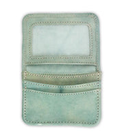 The Bed|Stü Jeor wallet in light green showcases its rustic leather construction, opening to reveal multiple credit card slots and a transparent ID window, with all compartments empty, photographed against a white background.