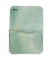 Introducing the Jeor card wallet by Bed|Stü—a light blue rustic leather wallet with white stitching. It features a single pocket and two small square markings in the upper left corner. This compact accessory is perfect for carrying your essentials in style.
