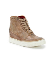 A single Joyce II high-top sneaker by Bed|Stü, crafted in brown leather with tan laces and a lace-up front, featuring a white rubber sole and shown angled to the left against a white background.