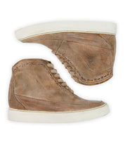 The Bed|Stü Joyce II sneakers are brown leather high-tops featuring a lace-up front and white rubber soles, shown side by side on a white background.