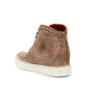 Bed|Stü Joyce II high-top sneaker in brown leather featuring a worn texture, lace-up front, white rubber sole, and red inner lining, shown from the back left angle.