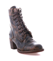 A single Judgement boot by Bed|Stü, crafted from brown leather with a cap toe, lace-up front, block heel, distressed finish, and visible stitching, is photographed against a white background.