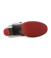 A black "Judgement" cap toe dress shoe by Bed|Stü shown from the bottom, featuring a red sole with embossed geometric patterns and the word "Bed|Stü" on the heel and toe.