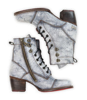 Bed|Stü Judgement distressed gray leather lace-up boots feature a cap toe design, wooden block heels, side zippers, and metal eyelet details, shown on a white background.