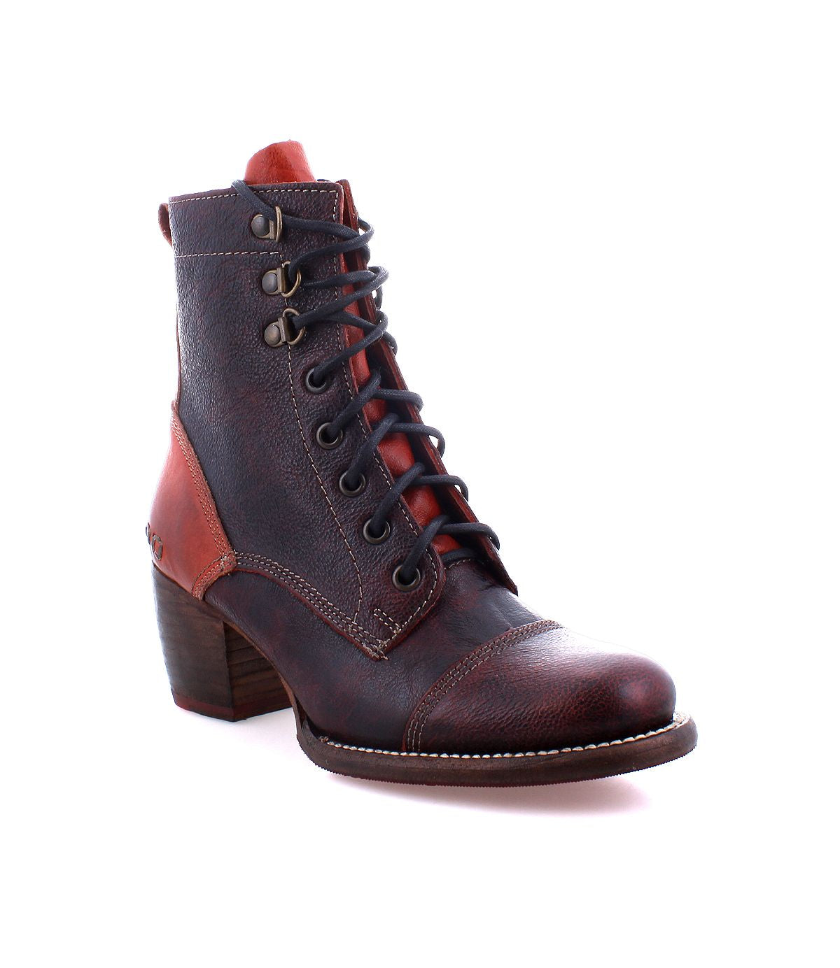 The Judgement boot by Bed|Stü is a brown leather lace-up style featuring a block heel, visible stitching, metal eyelets, cap toe detailing, and bold red accent panels, displayed against a white background.