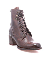 The Bed|Stü Judgement is a brown leather lace-up boot with a block heel and stitched detailing, featuring a cushioned insole for added comfort, displayed on a white background.
