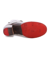 A brown leather dress shoe from Bed|Stü, the Judgement, is shown from the bottom, highlighting its red rubber sole with embossed branding and edge stitching, and features a cushioned insole for enhanced comfort.