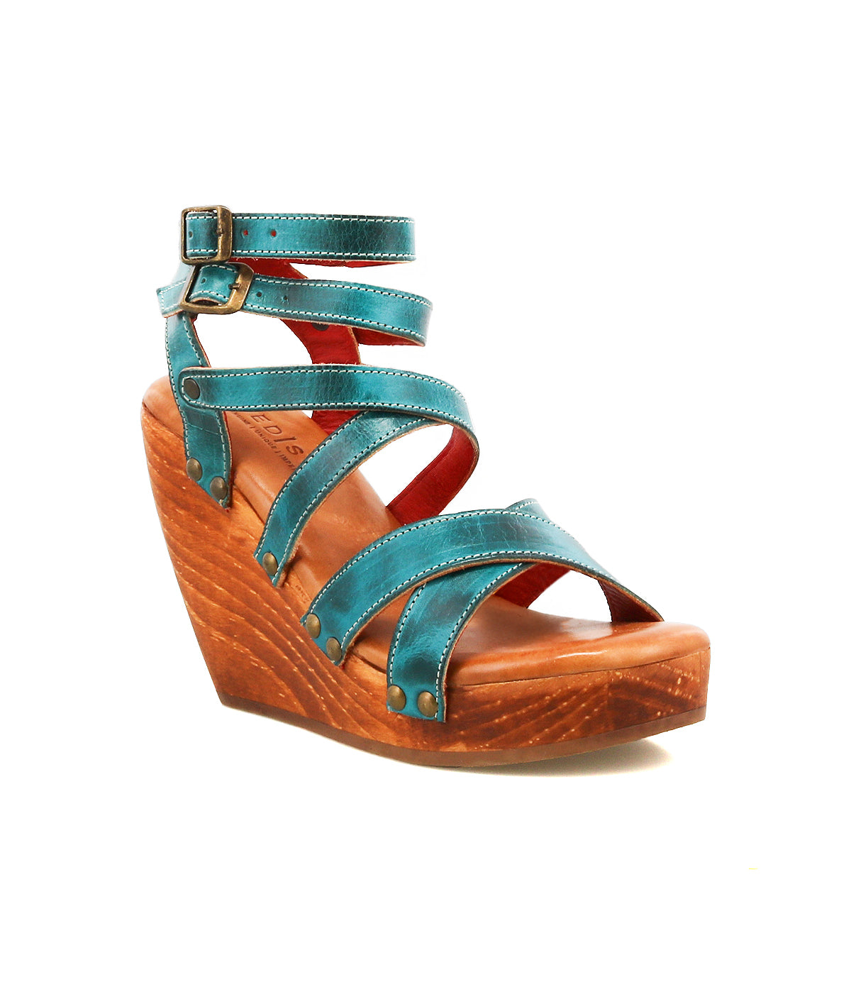 The Bed|Stü Juliana II is a teal wedge sandal featuring a strappy upper, a wooden wedge platform heel, and an ankle buckle, displayed on a white background.