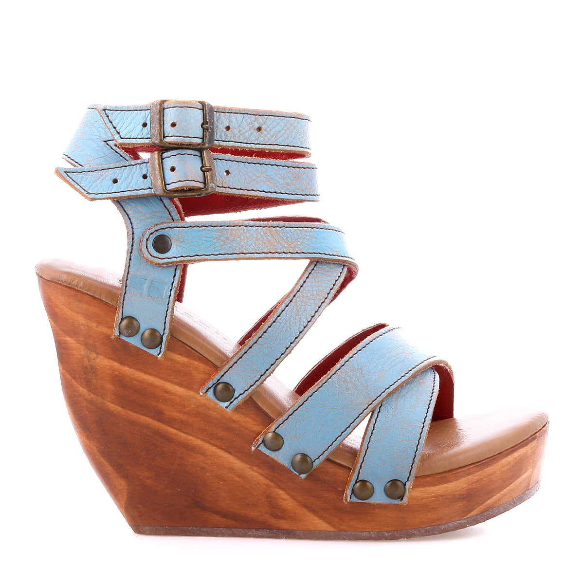The Juliana II by Bed|Stü is a blue wedge platform sandal, featuring a stylish strappy upper, double ankle buckle closure, and a chic wooden wedge sole, shown in profile against a white background.
