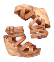 A pair of Bed|Stü Juliana II tan leather wedge sandals featuring a wooden platform, strappy upper with decorative studs, and buckle closures, shown from side and top views.