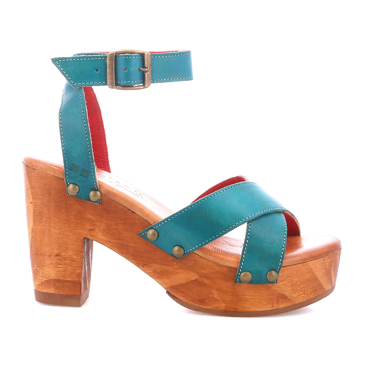 The Kalah by Bed|Stü is a teal leather sandal with an adjustable ankle strap and buckle, brass rivet accents, and a chunky platform heel crafted from sustainably sourced wood.