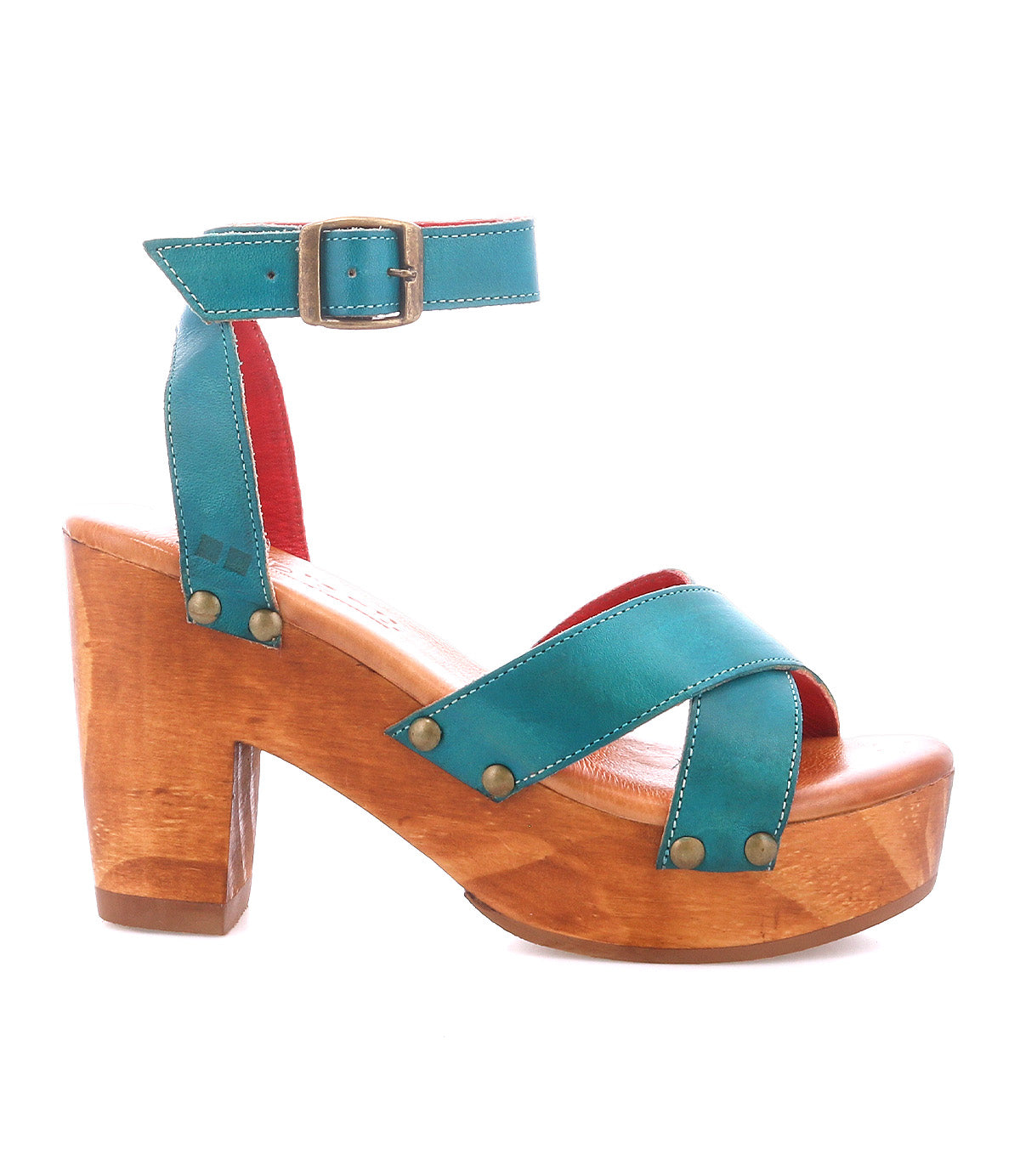 The Kalah by Bed|Stü is a teal leather sandal with an adjustable ankle strap and buckle, brass rivet accents, and a chunky platform heel crafted from sustainably sourced wood.