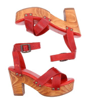 The Kalah platform sandals by Bed|Stü feature a red leather upper, an adjustable ankle strap, and a sustainably sourced wooden heel, displayed from the side and top views against a white background.