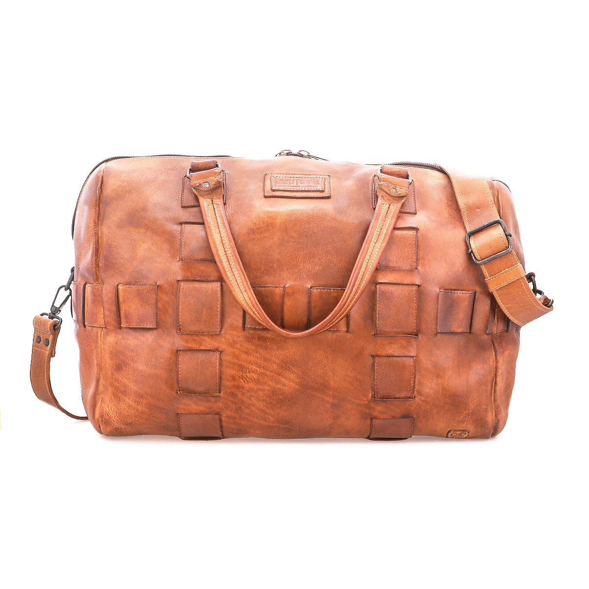 Bed|Stü Keg is a brown leather duffel bag crafted from premium vegetable tanned leather, showcasing a woven square pattern, two handles, detachable shoulder strap, and zippered top closure. Photographed against a white background, this travel bag combines timeless style with lasting durability.