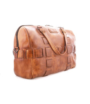 Bed|Stü Keg brown leather duffel bag, crafted from vegetable tanned leather and featuring two handles, a zipper closure, and square stitched accents, shown on a white background. Ideal as a stylish travel bag.