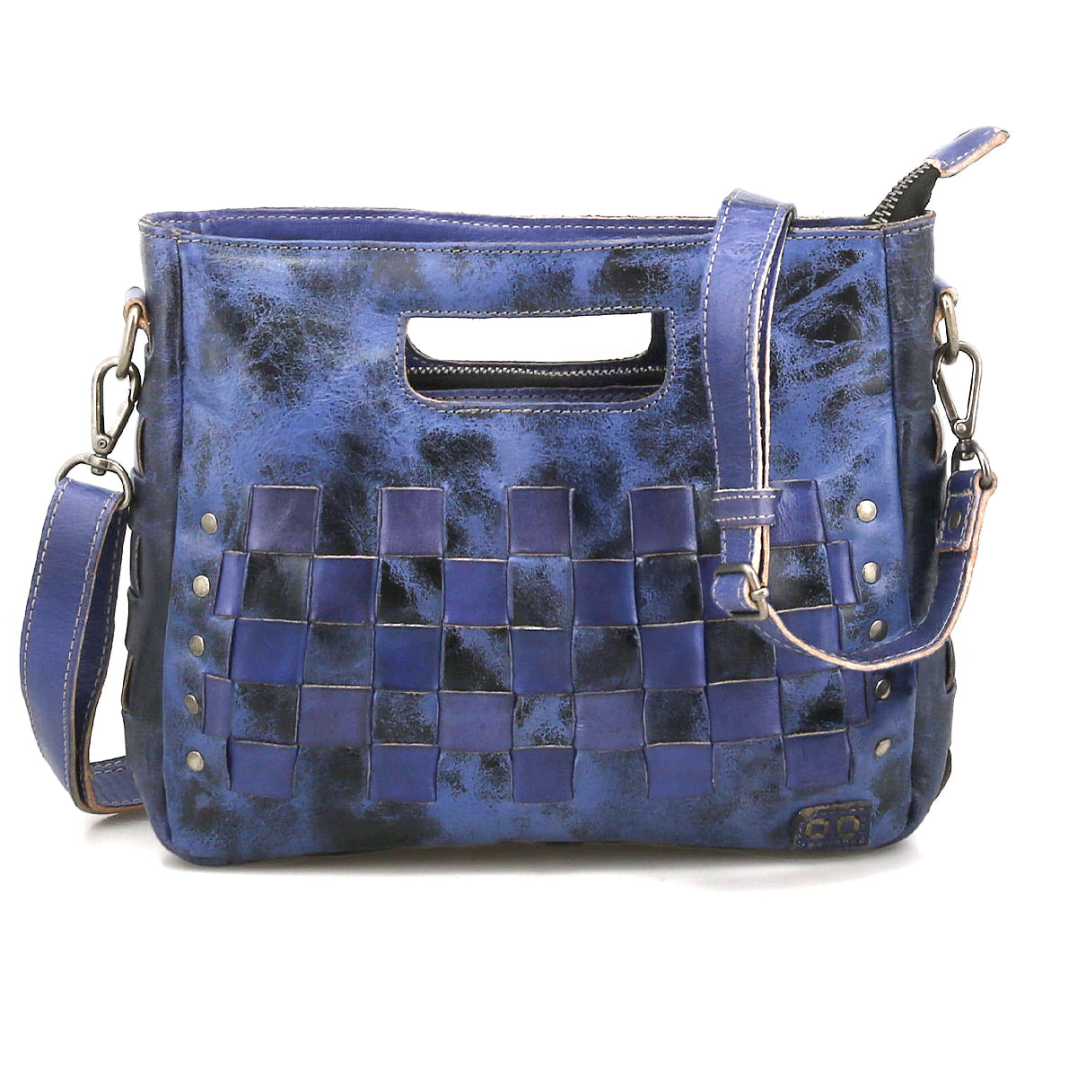 The Keiki crossbody bag by Bed|Stü features blue leather in a checkerboard pattern, adorned with metal rivets, a zip-top closure, an adjustable detachable shoulder strap, and a stylish cutout top handle.