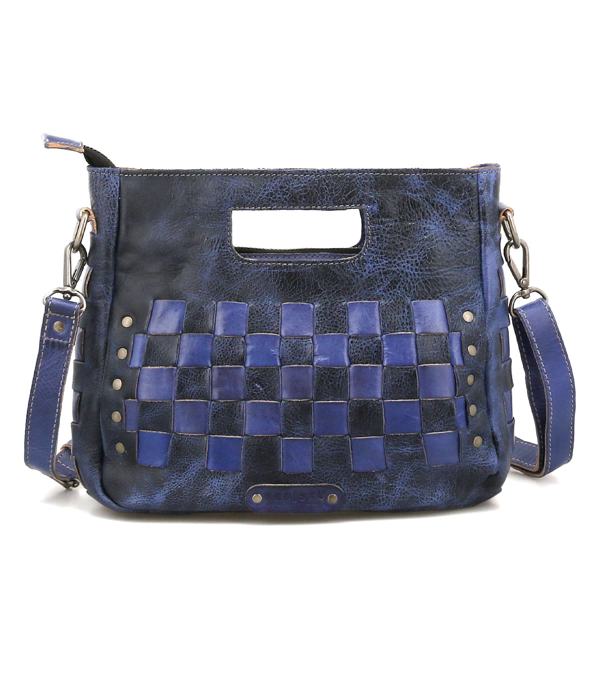 The Keiki by Bed|Stü is a rectangular blue leather handbag featuring a woven checkerboard pattern on the front, a cut-out handle, metal studs, an adjustable strap, and a secure zip-top closure.