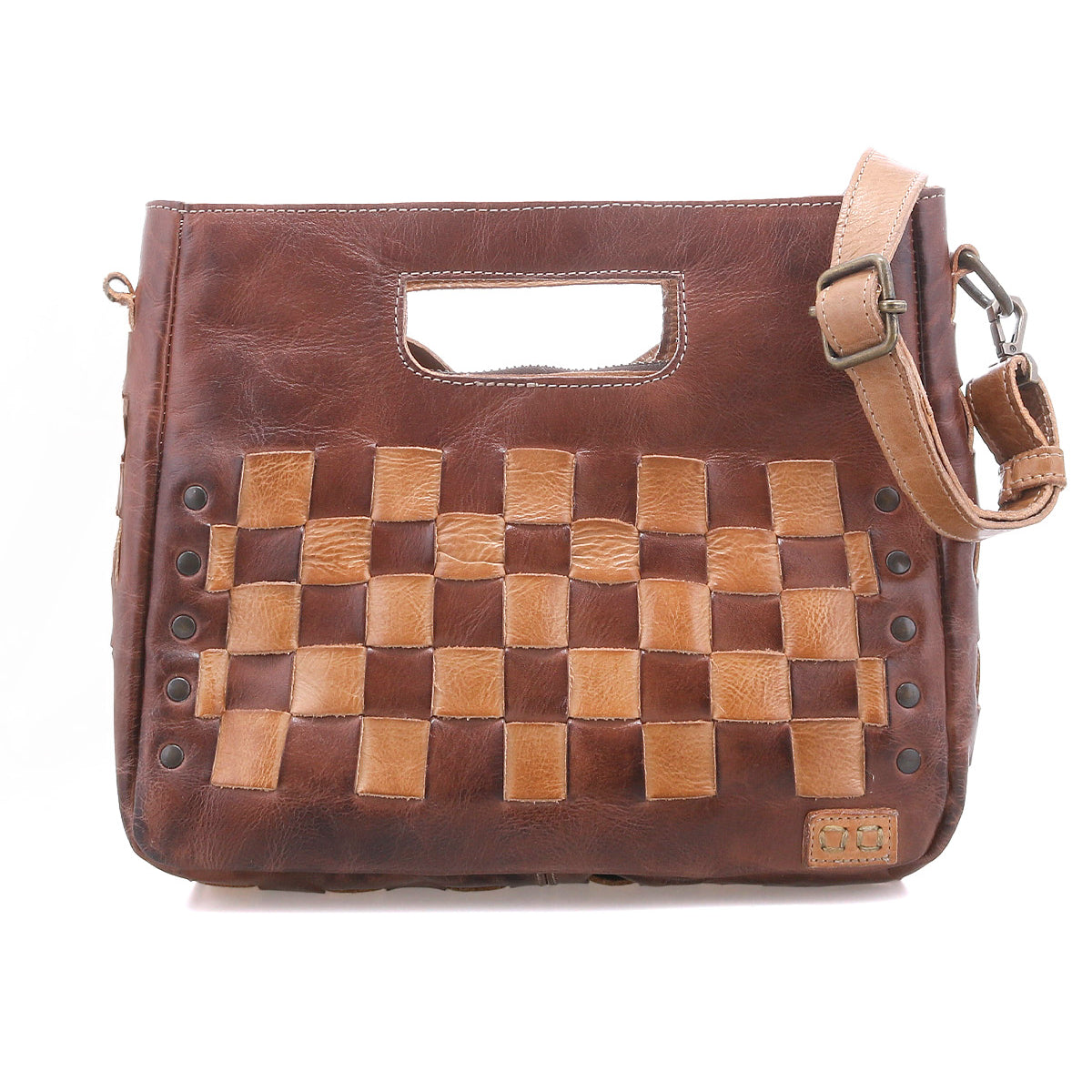 Discover the Keiki by Bed|Stü: a brown leather handbag featuring a woven light and dark checkerboard front, cutout handle, metal studs, zip-top closure, and an adjustable shoulder strap.