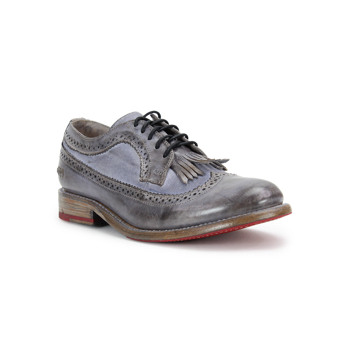 The Lita K by Bed Stu features a gray leather brogue style in a derby shape with a wingtip toe, fringe, black laces, and a red-soled wooden heel, showcased on a white background.