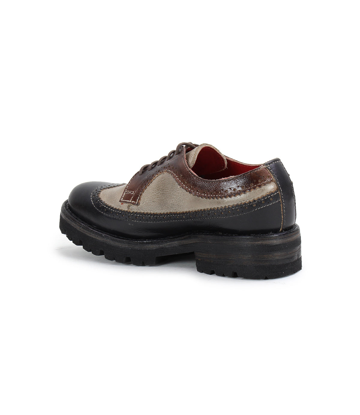 The Bed|Stü Lita K III is a brown and beige leather wingtip shoe with vintage-inspired styling and a thick black sole, shown from the side and slightly behind against a white background.