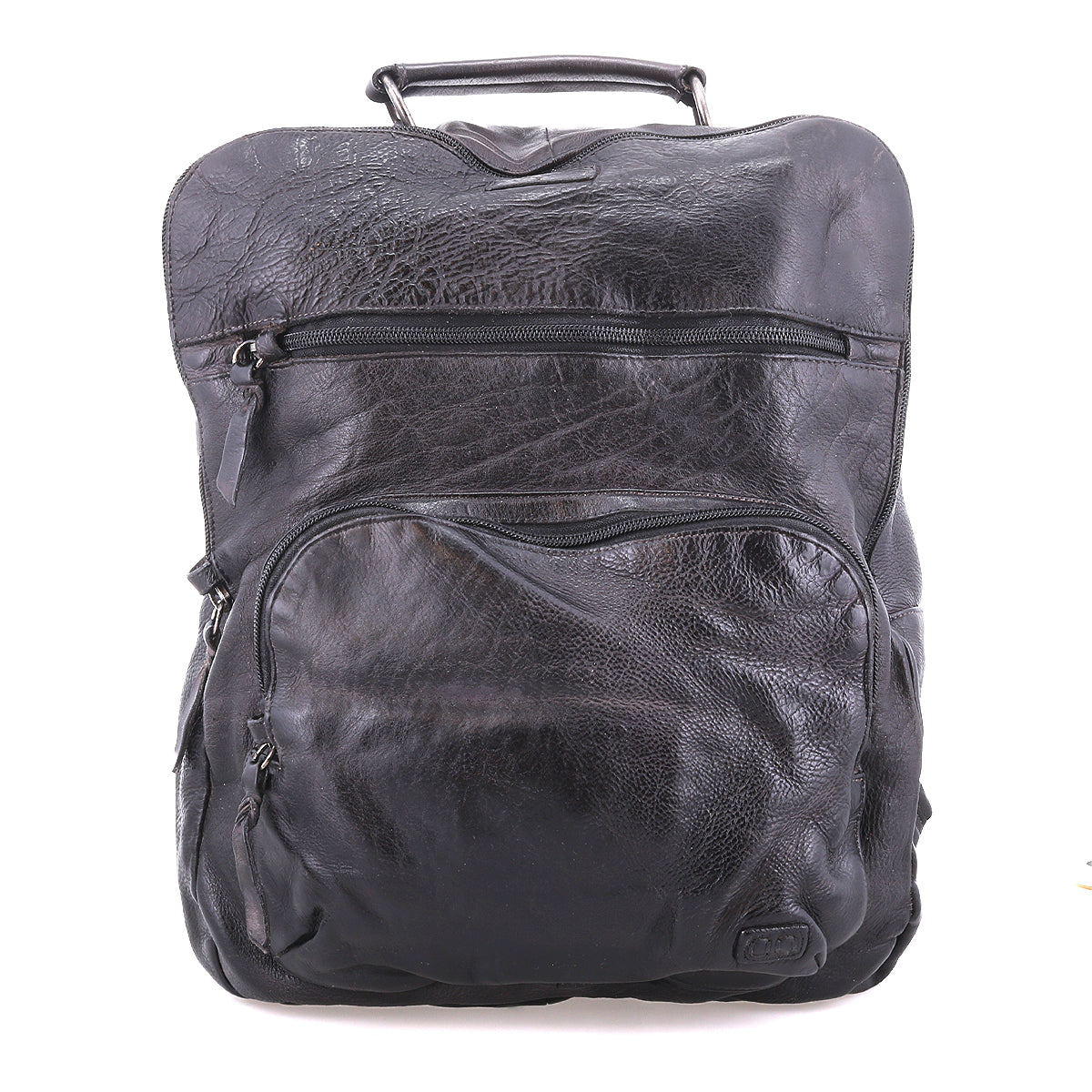 The Lafe backpack by Bed|Stü is a black leather anti-theft travel bag featuring a top handle and two front zippered pockets, displayed against a plain white background.