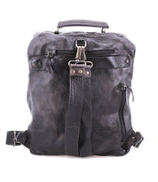 The Bed|Stü Lafe is a sleek black leather backpack, featuring metal zippers and buckles, a front handle, and a central strap, photographed against a white background. Designed as an anti-theft travel bag, the Lafe comfortably fits a 17-inch laptop while blending style and security for modern travelers.