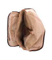 Discover the Lafe by Bed|Stü: an open tan canvas bag featuring a spacious, empty interior, an inner zippered pocket on the left, and a distinctive leather strap detail on the right—effortlessly combining classic style with the versatility of a leather backpack for all your daily adventures.