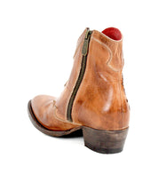 The Bed|Stü Laredoa boot is a brown leather ankle boot featuring a side zipper, low heel, and visible stitching, inspired by classic Western boots and shown from the back and side on a white background.