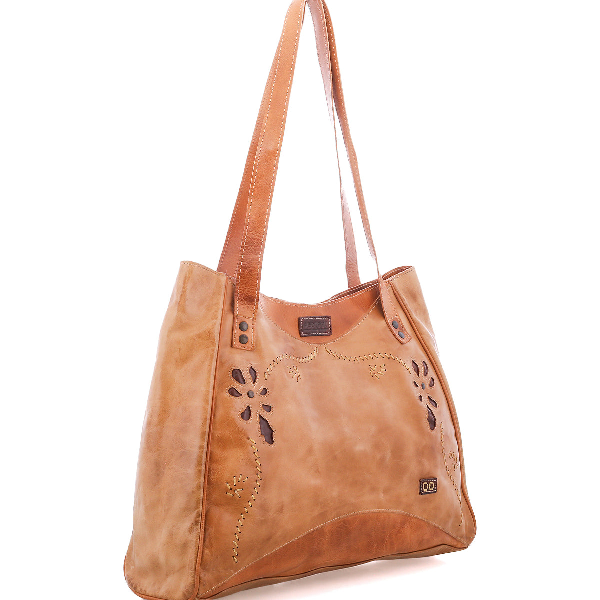 The Bed|Stü Larue LTC is a tan leather shoulder bag with decorative cutouts, metal studs, and double straps, shown on a white background.