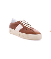 The Law sneakers by Bed|Stü are brown and white low-top luxury leather shoes featuring white laces and a thick off-white sole, expertly crafted in Italy and photographed against a white background.
