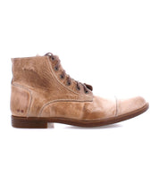 Introducing the Bed|Stü Leonardo: a single light brown leather lace-up boot with a slightly worn finish, low heel, and cap toe. This boot features a cushioned insole and flexible rubber outsole and is shown in profile facing left against a white background.