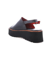 A single black "Library" platform sandal by Bed|Stü, featuring an open back, ankle strap, and thick ridged sole, is displayed on a white background—perfect for adding a touch of retro footwear to your look with its unmistakable ‘90s style.