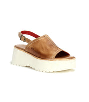 Step out in retro flair with Bed|Stü’s Library sandal—a brown open-toe leather platform featuring a chunky white sole, adjustable ankle strap, and striking red inner lining, captured against a white background for the perfect ‘90s-inspired statement.
