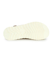 The underside of the Bed|Stü Library’s white rubber sole, featuring a wavy tread pattern and photographed against a white background, evokes retro footwear vibes with subtle hints of ‘90s style.