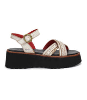 The Bed|Stü Lift sandal features white leather crisscross straps, a gold buckle, bold red interior detailing, and a thick black platform sole—shown in side view for a chic yet comfortable option.
