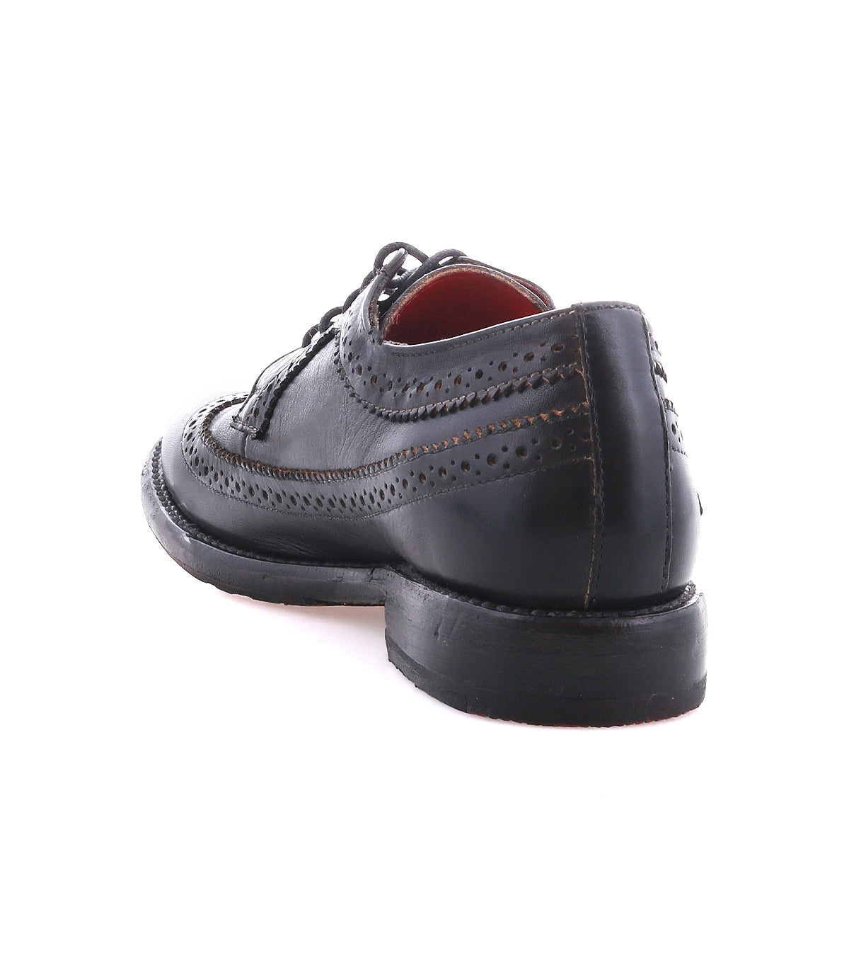 The Bed|Stü Lita K II is a black leather classic derby dress shoe with refined brogue detailing and a wingtip toe, shown from the back left angle against a white background.