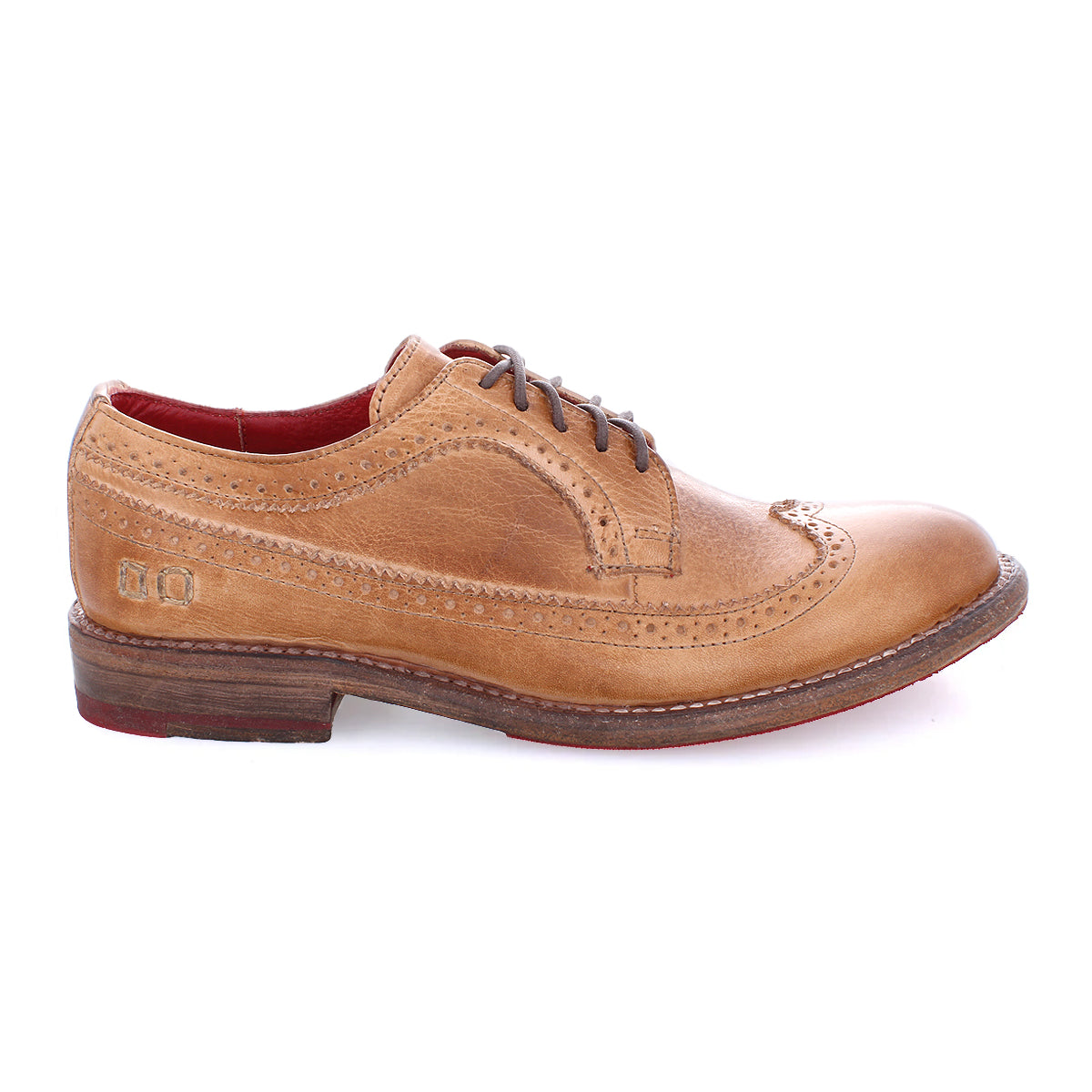 Introducing the Bed|Stü Lita K II: a tan leather classic derby brogue dress shoe with a wingtip toe and intricate decorative perforations, featuring dark laces, a brown sole, and a striking red inner lining, shown in side profile against a white background.