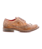 The Bed|Stü Lita K II is a brown leather classic derby dress shoe featuring brogue detailing, laces, visible stitching details, and a slightly worn appearance, with a wingtip toe design and shown from the side on a white background.