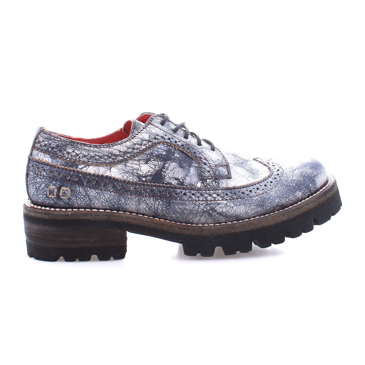 The Bed|Stü Lita K III is showcased against a white background—a single gray leather brogue shoe featuring a thick black sole, visible stitching, and decorative perforations that capture the refined charm of this vintage-inspired design.