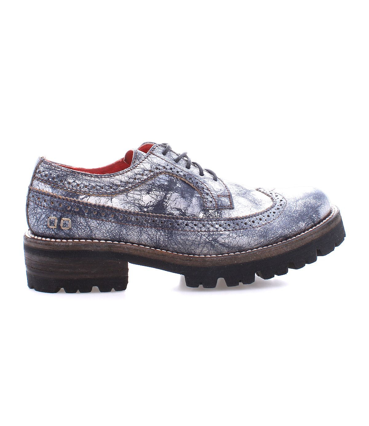 The Bed|Stü Lita K III is showcased against a white background—a single gray leather brogue shoe featuring a thick black sole, visible stitching, and decorative perforations that capture the refined charm of this vintage-inspired design.