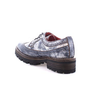 A single Lita K III lace-up dress shoe by Bed|Stü, featuring a textured, distressed silver finish and a thick, rugged dark sole—this vintage-inspired shoe is shown from the rear side.