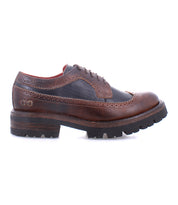 Introducing the Lita K III by Bed|Stü: a brown and black leather wingtip brogue shoe with a thick treaded sole, inspired by vintage designs and photographed from the side against a white background.
