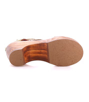 The image shows the bottom view of the Bed|Stü Locket sandal, featuring a sculpted wooden heel and a beige rubber sole, isolated on a white background.